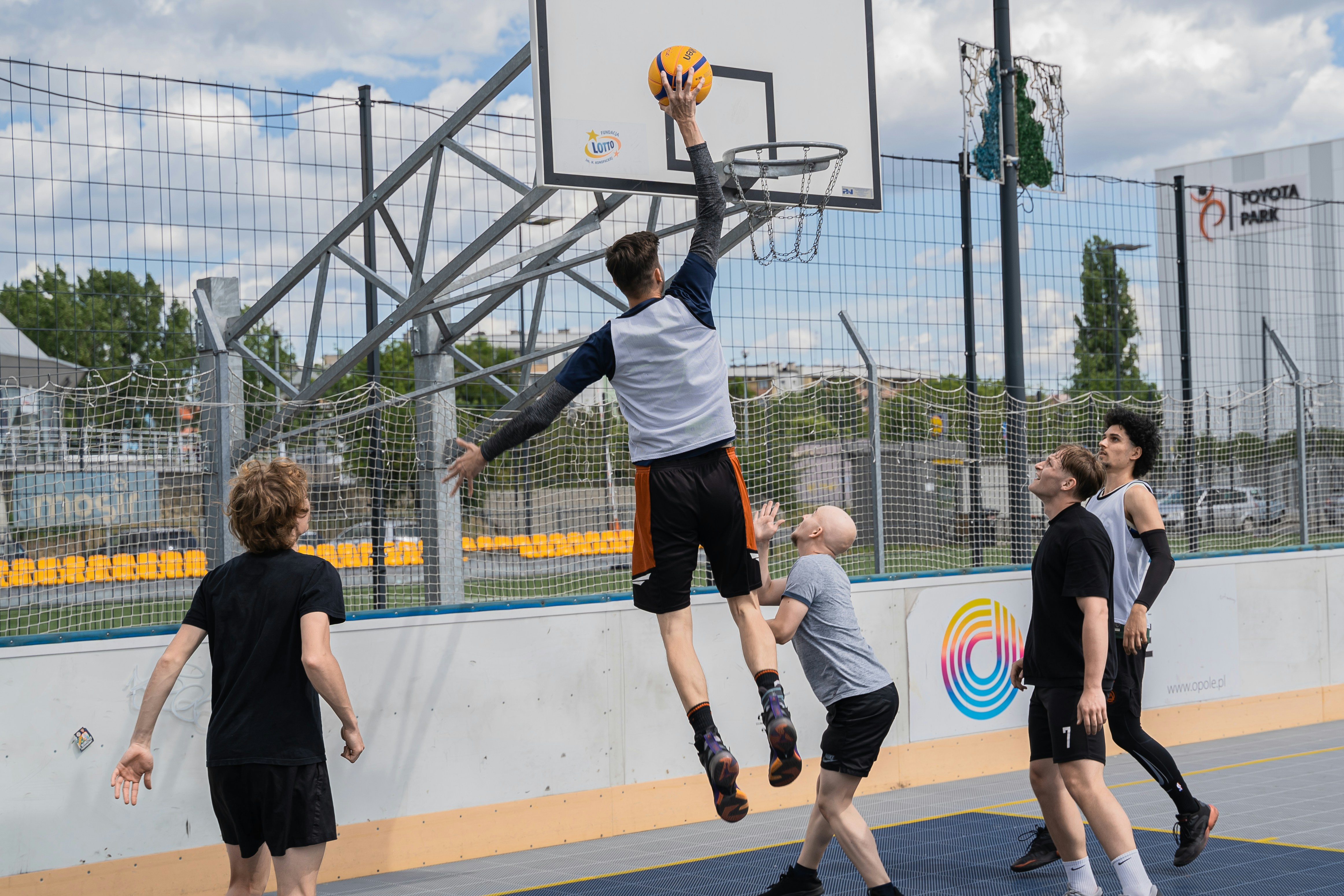 Basketball player jumps to shoot a basket.