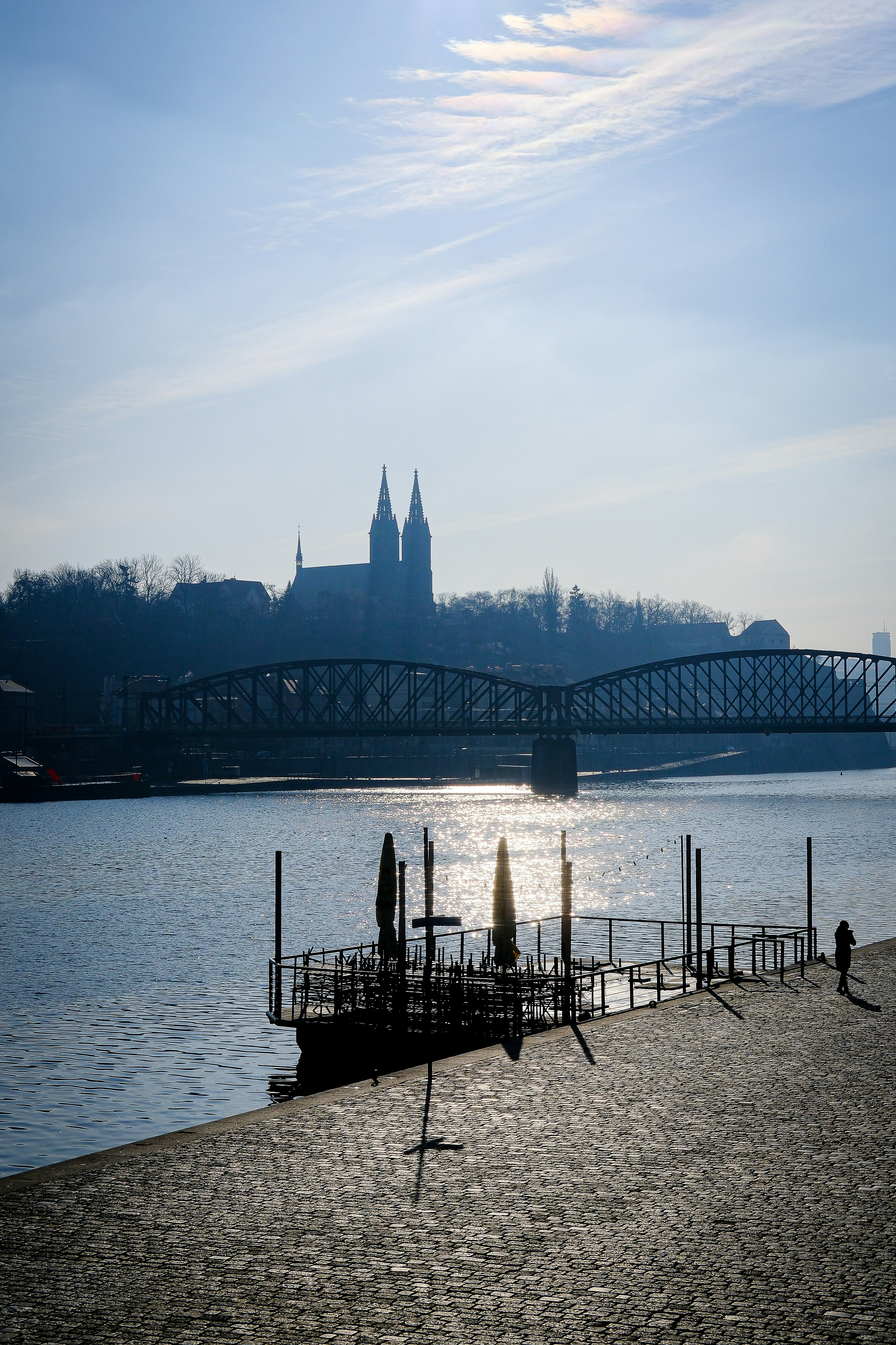 Cityscape with a river and a silhouette.
