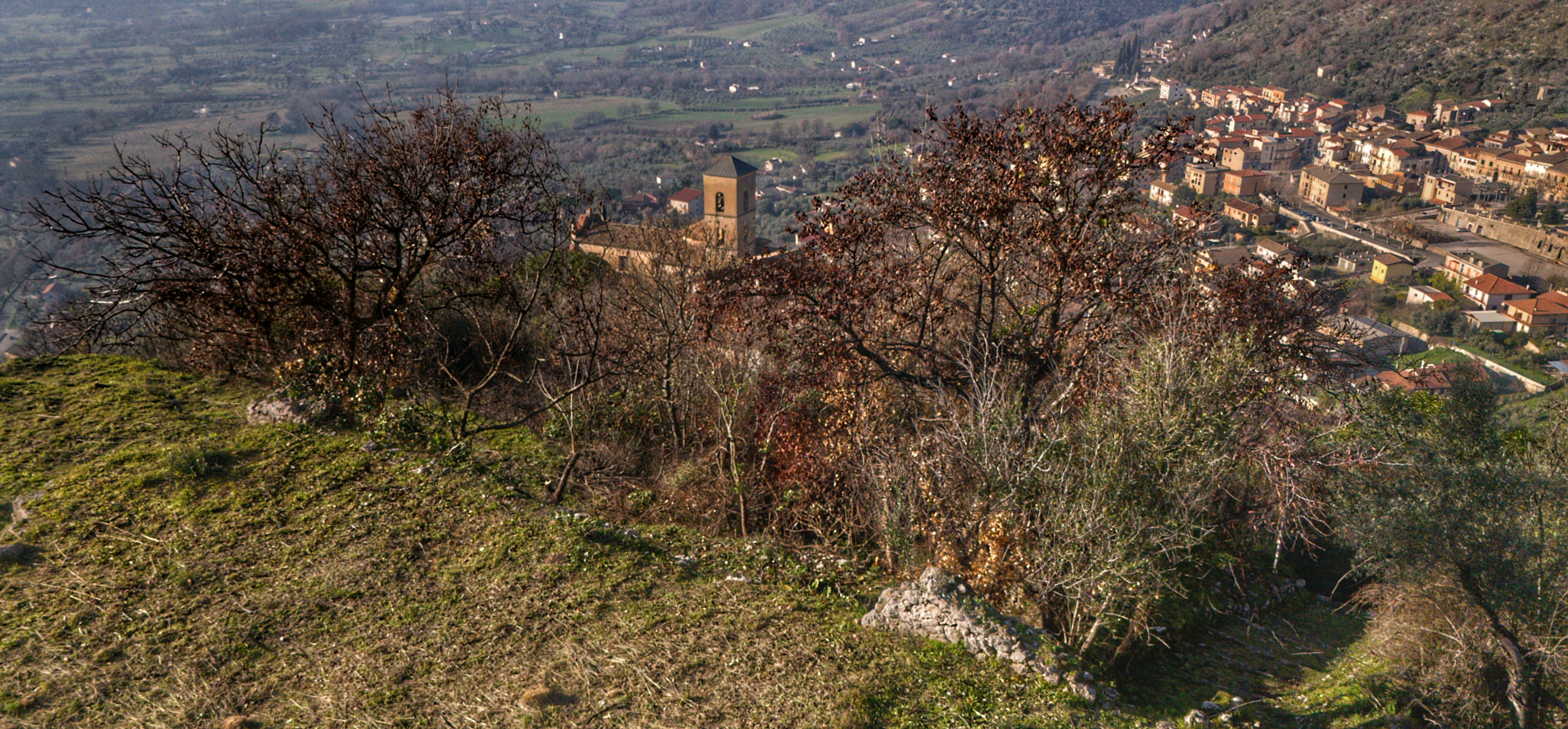 A hilltop view of a town and a church.