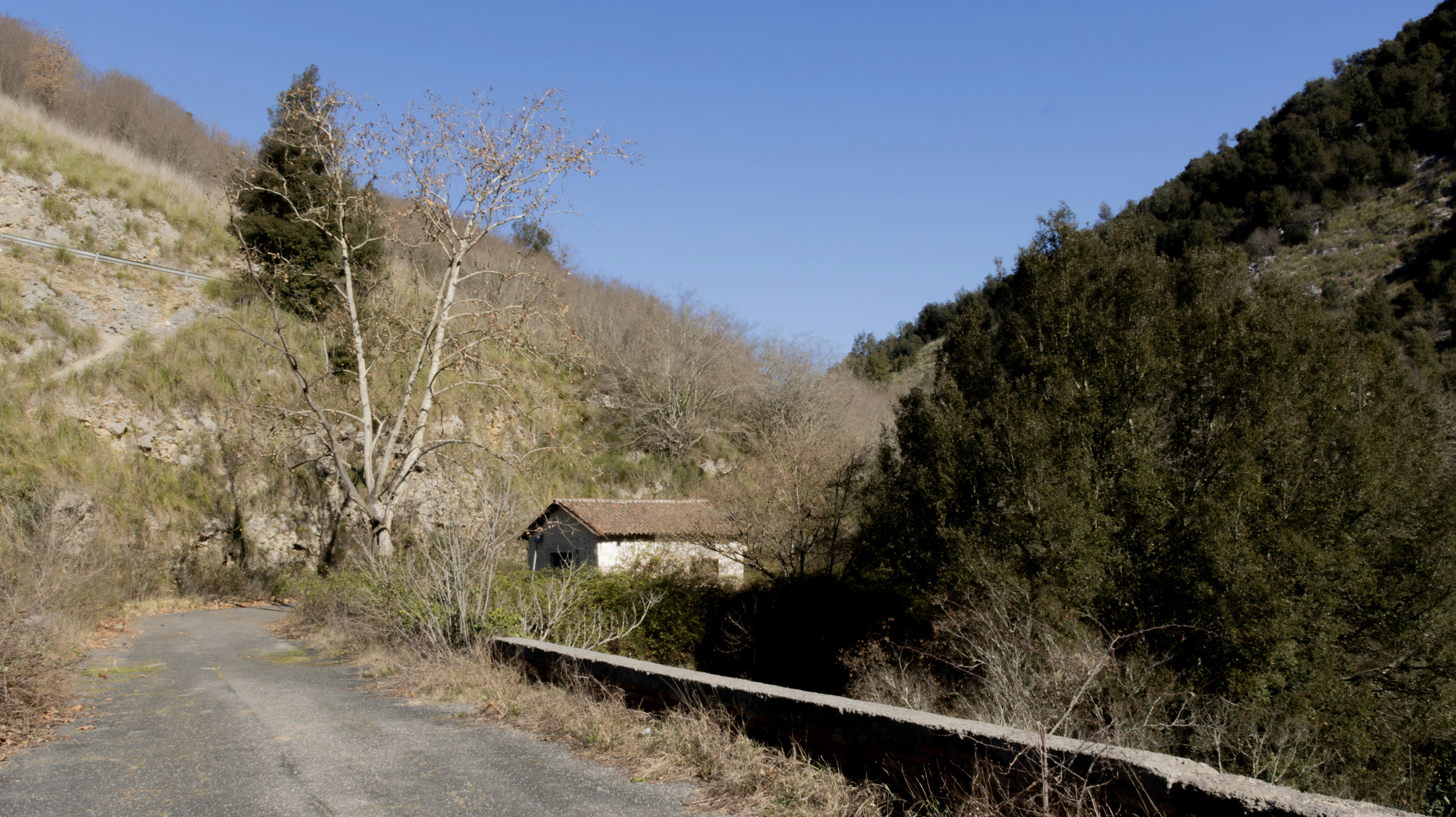 A small house sits in a valley.