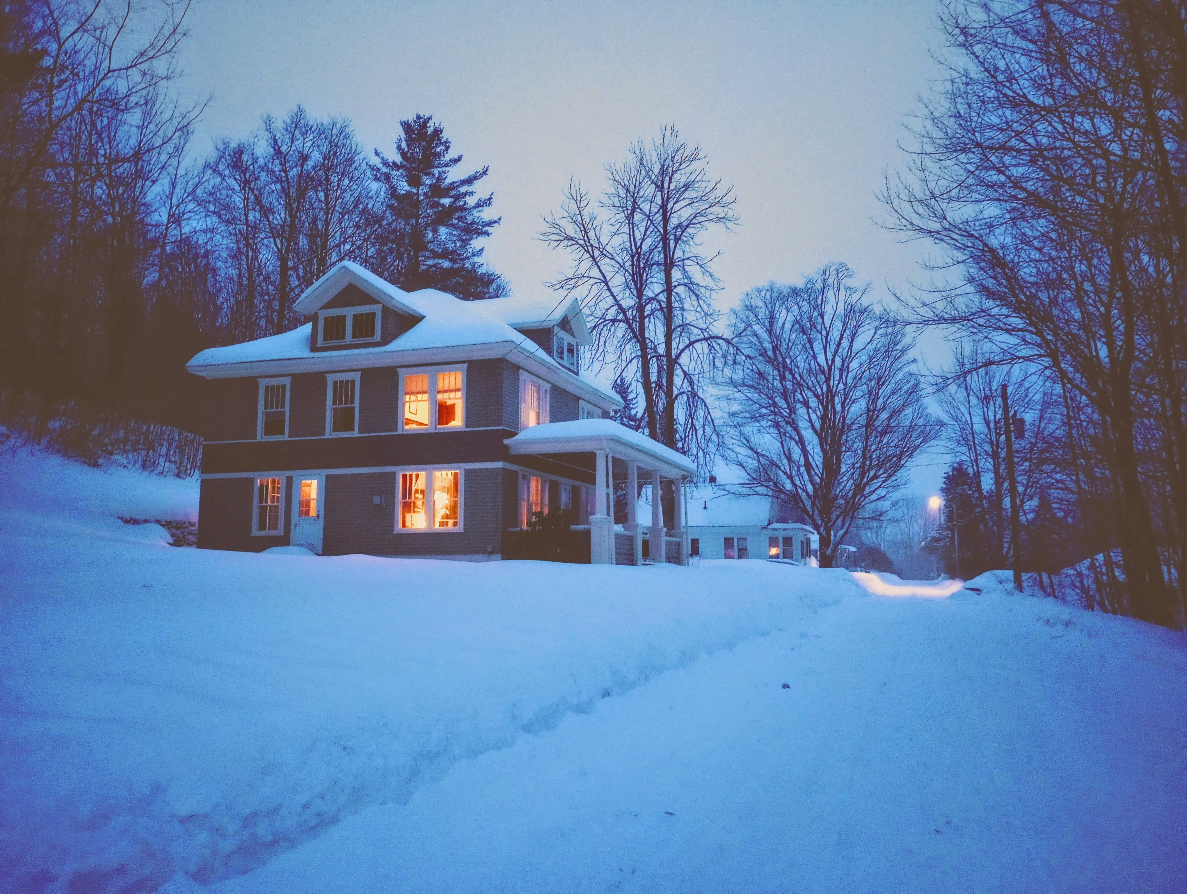 Cozy house surrounded by snow in winter season.