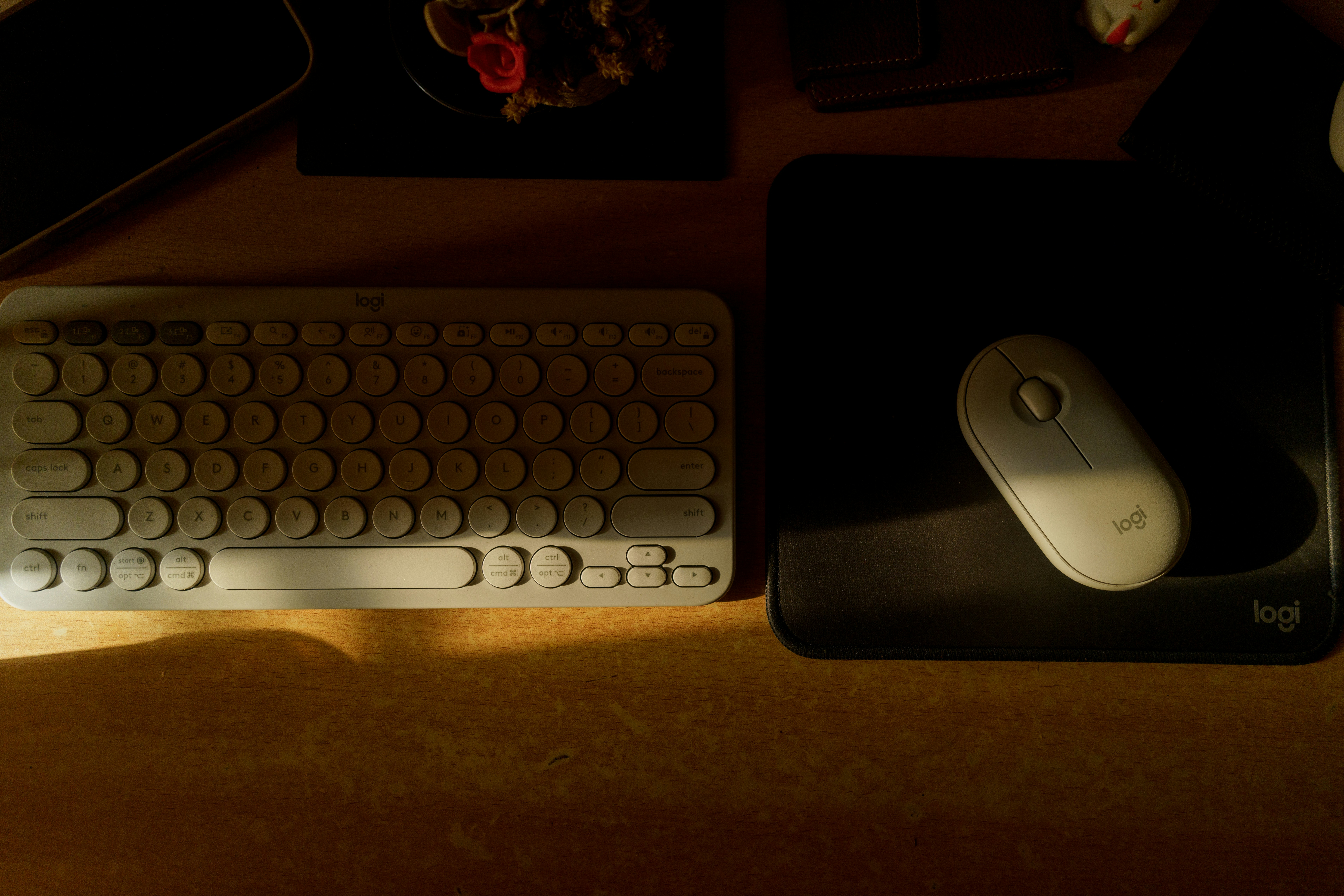 Keyboard, mouse, and mousepad on a desk.