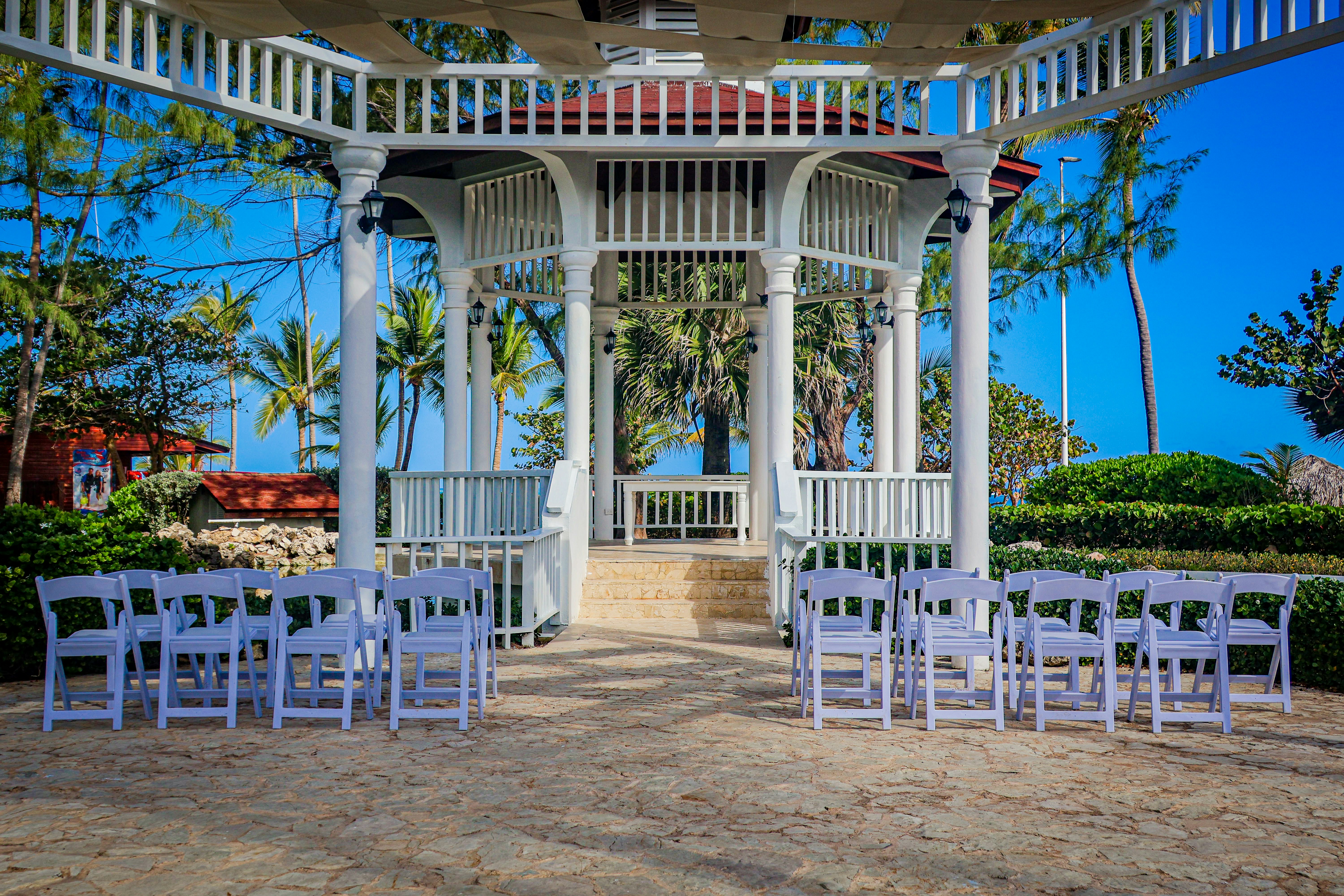 Wedding ceremony setup with chairs in front of gazebo.