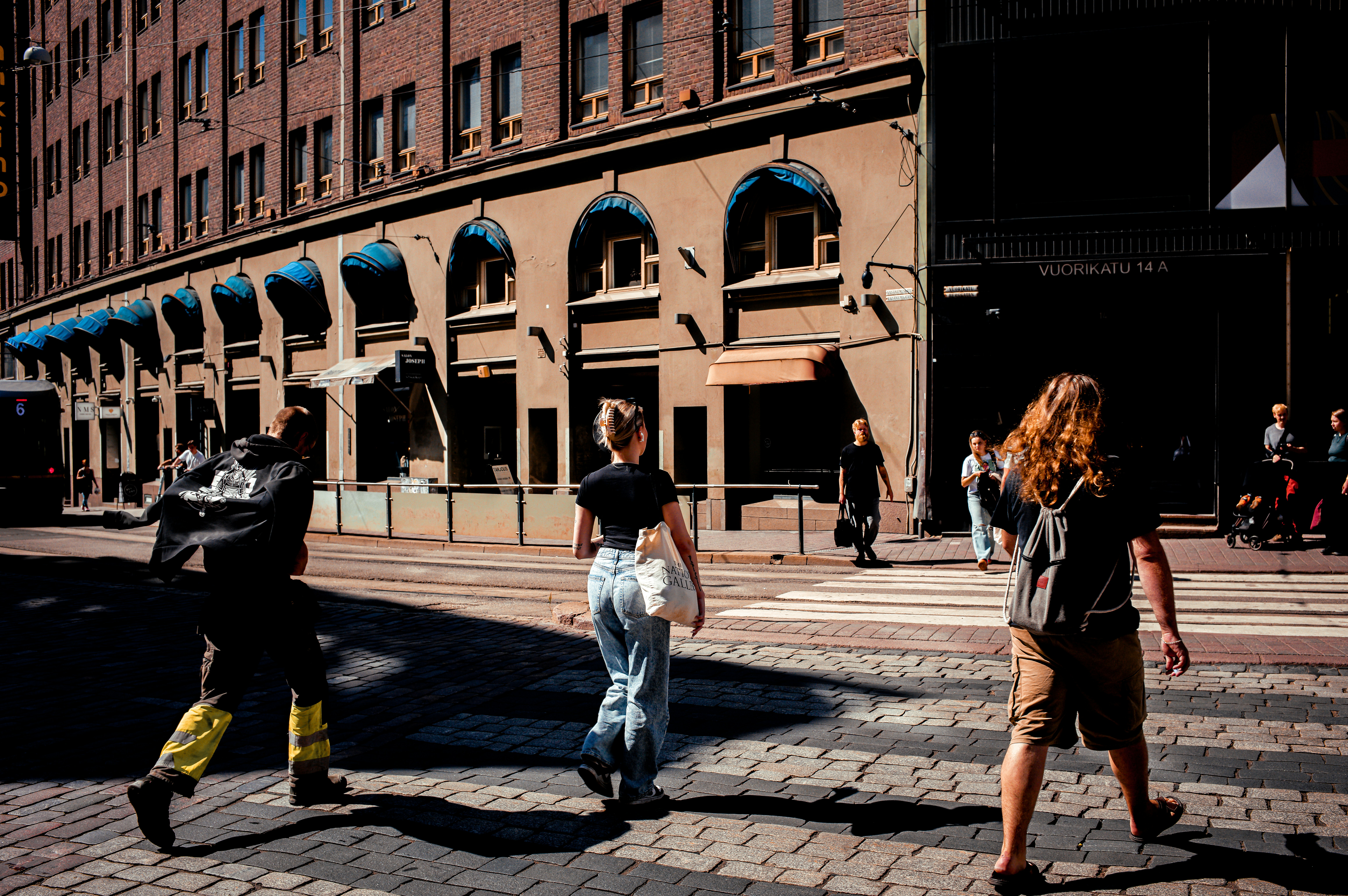 Piétons traversant un passage clouté dans une ville finlandaise animée