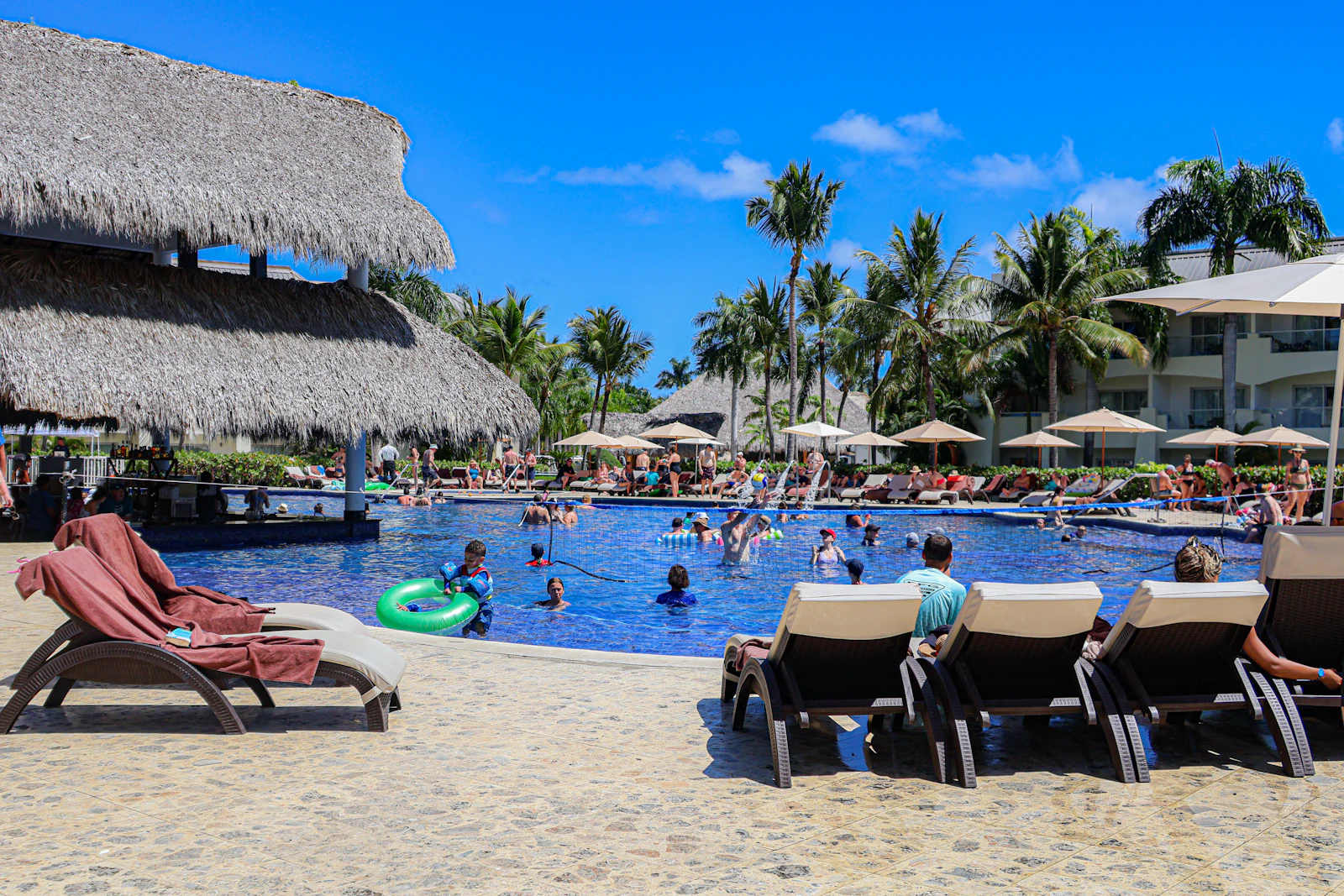 Guests swimming and relaxing at a resort pool