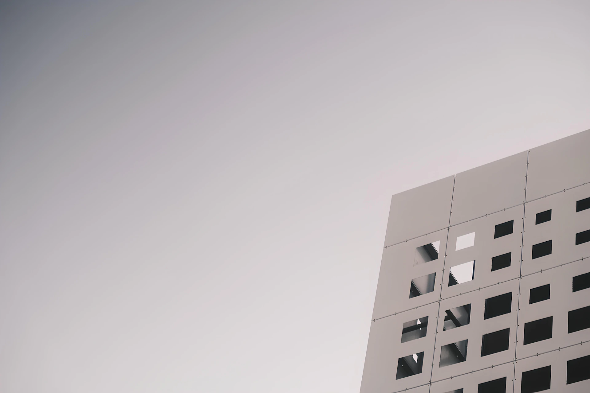 White building with geometric square cutouts.