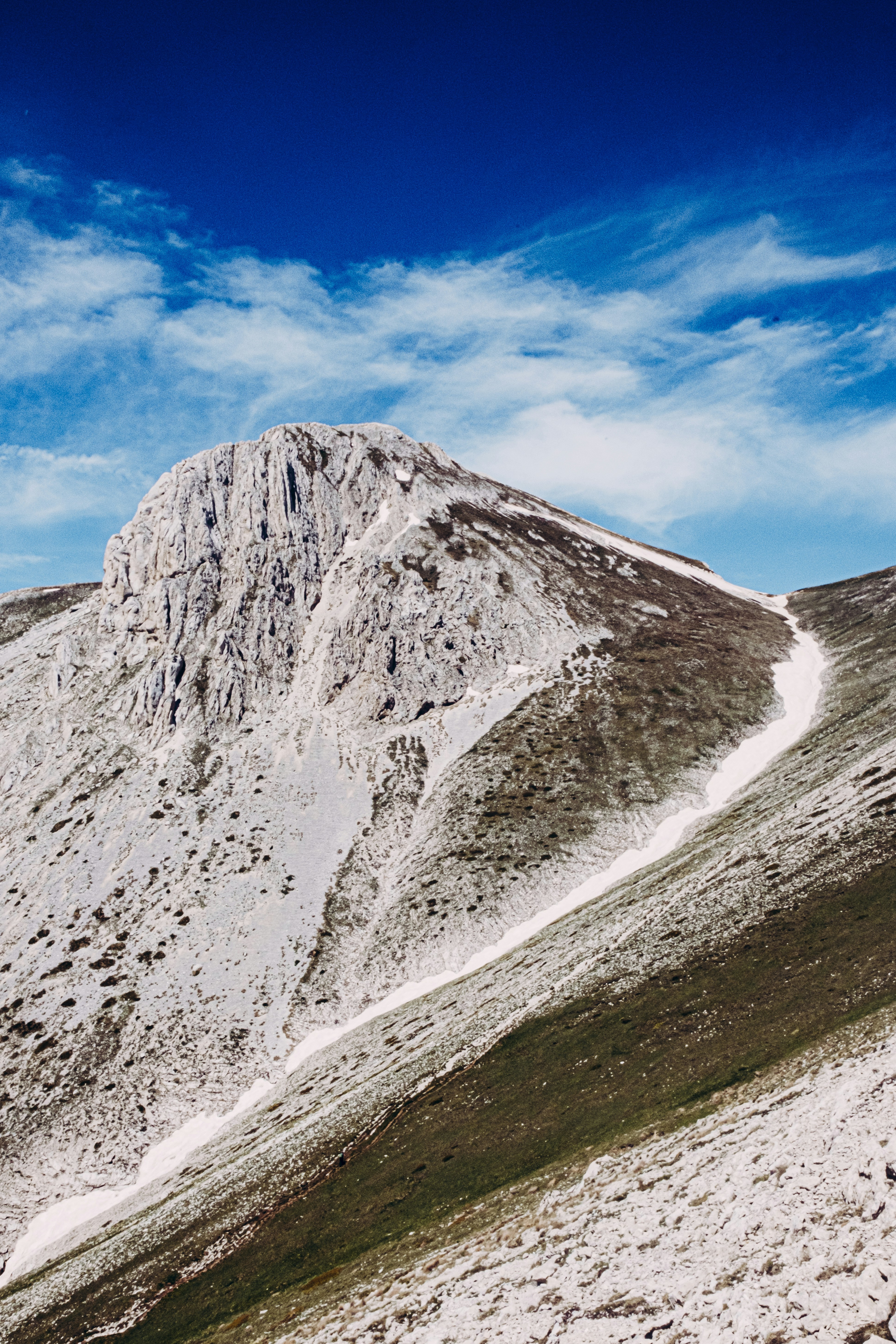 Snowy mountain peaks under a blue sky.