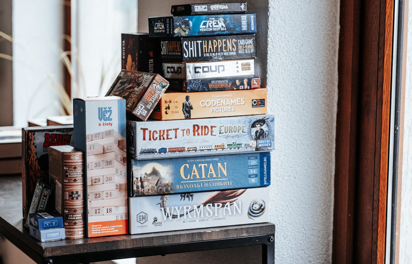 Board games stacked on a shelf