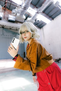 Woman with a phone poses for a selfie.