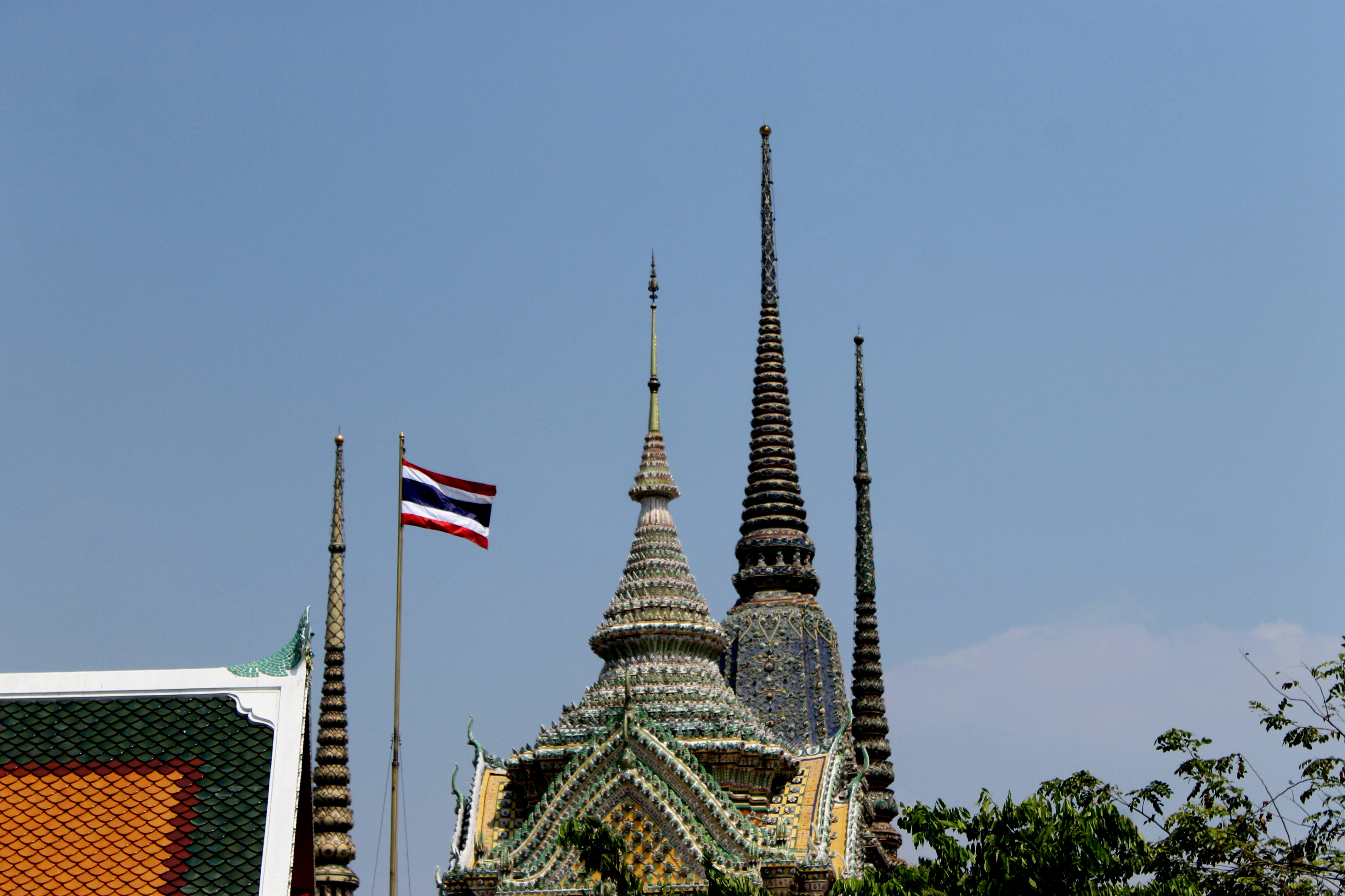 Thai temple spires with flag flying high.