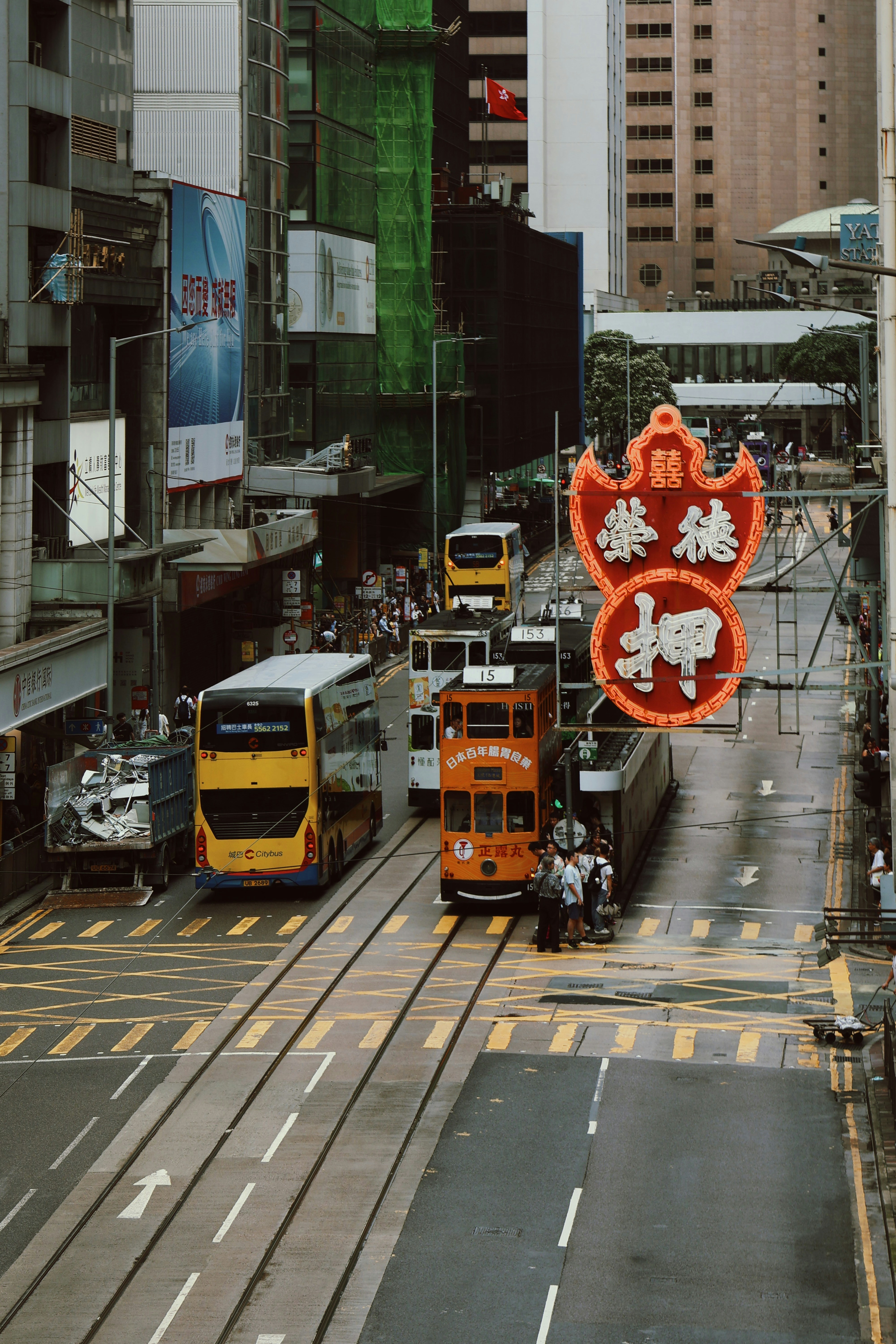 Traffic and trams in a bustling city street.