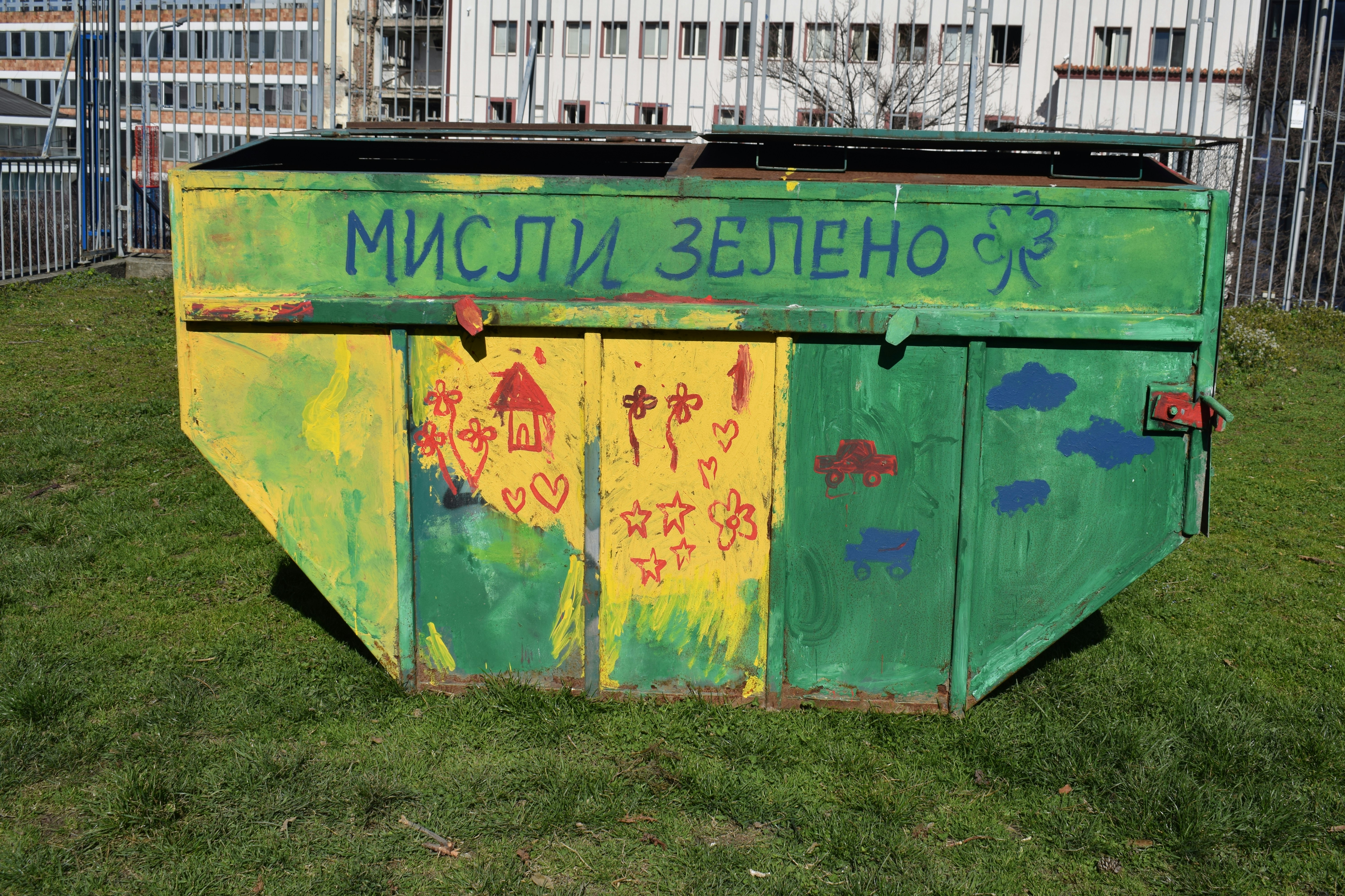 A colorful, green dumpster with the text "think green."