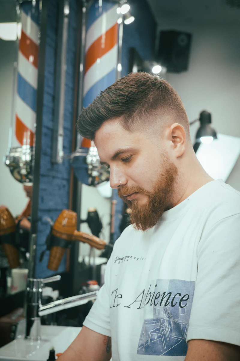 A barber styling a customer's hair