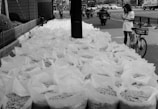 Bags filled, lining the sidewalk.