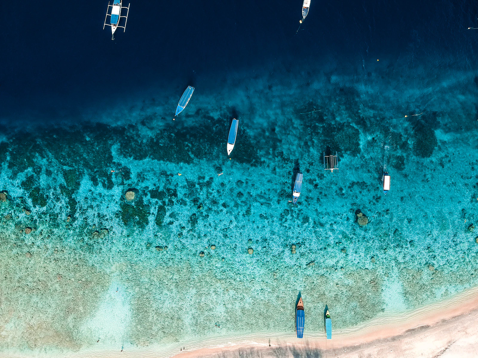 Boats on turquoise water at Gili Trawangan, Indonesia