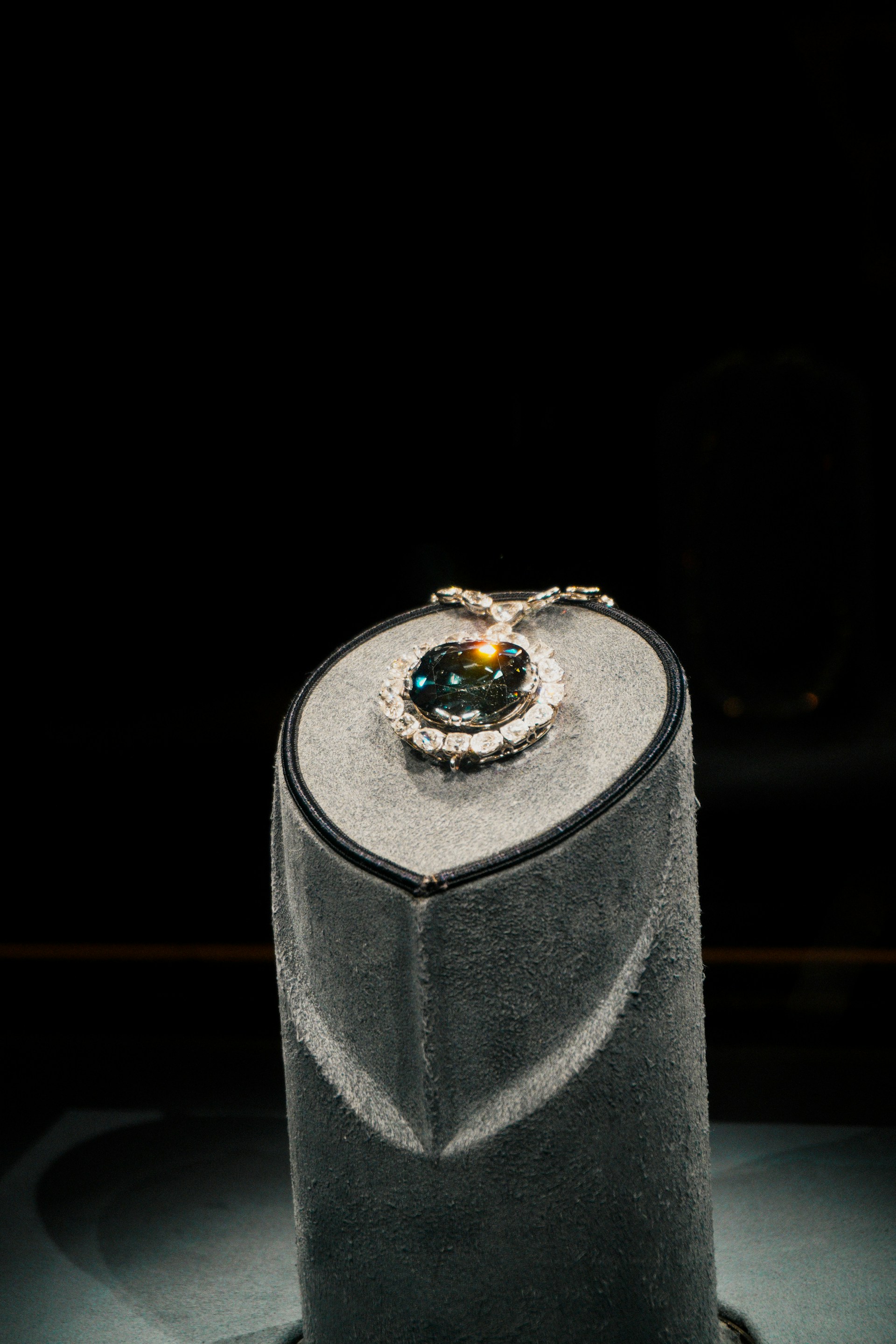 A sparkling blue diamond necklace is on display.