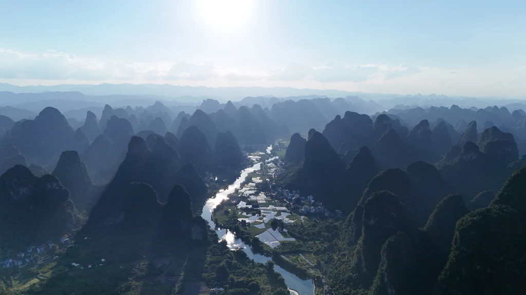 A winding river between steep limestone karst hills near Yangshuo in Guangxi