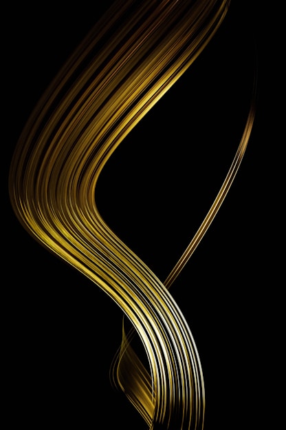 Golden ribbons flowing on a dark background.