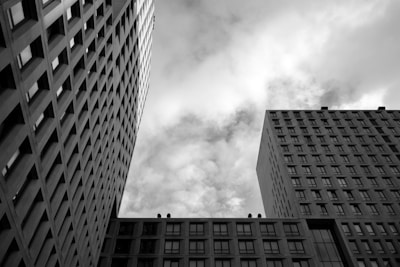 Skyscrapers tower beneath a cloudy, grey sky.