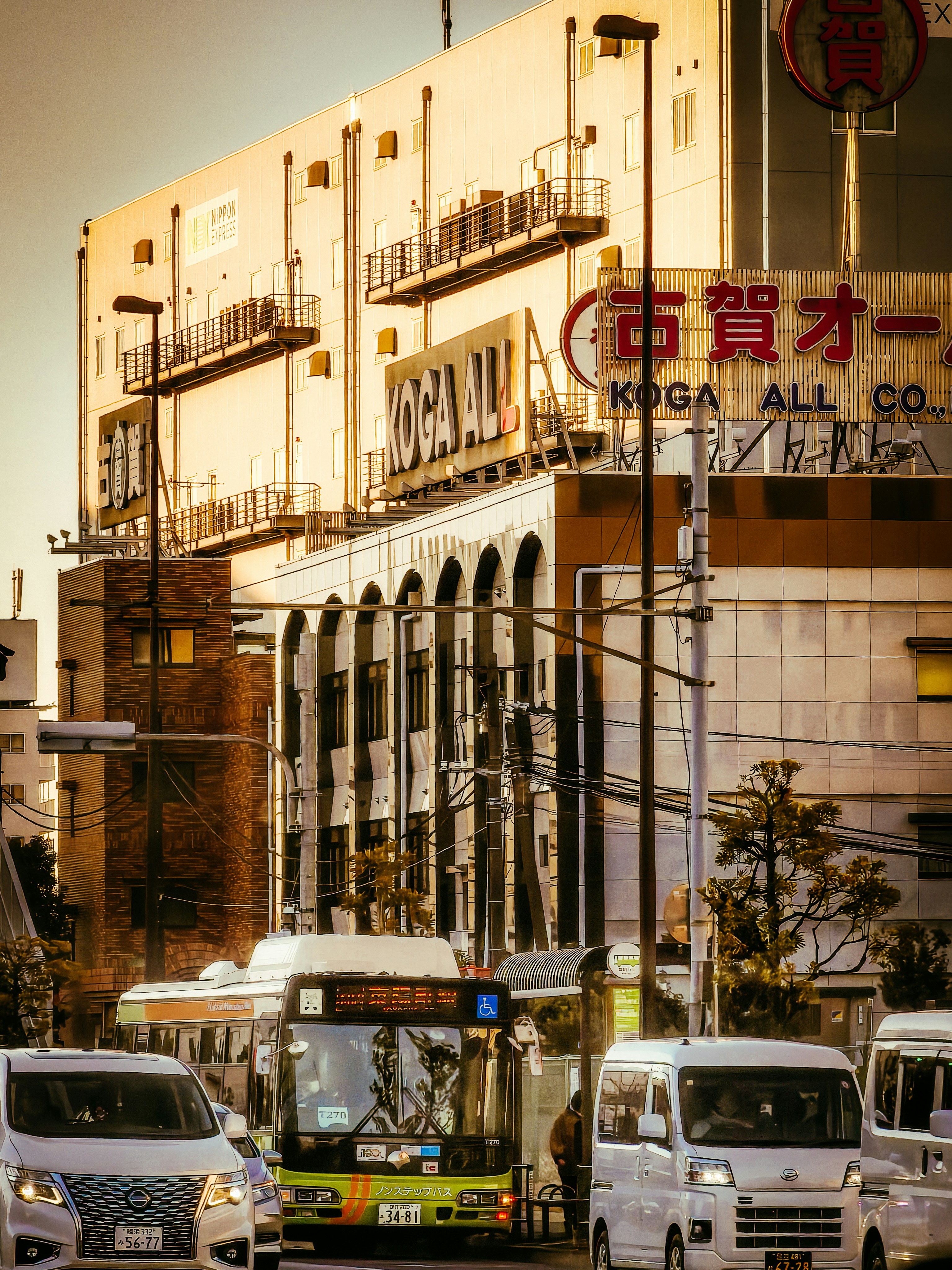 Busy street scene with buildings and a bus.