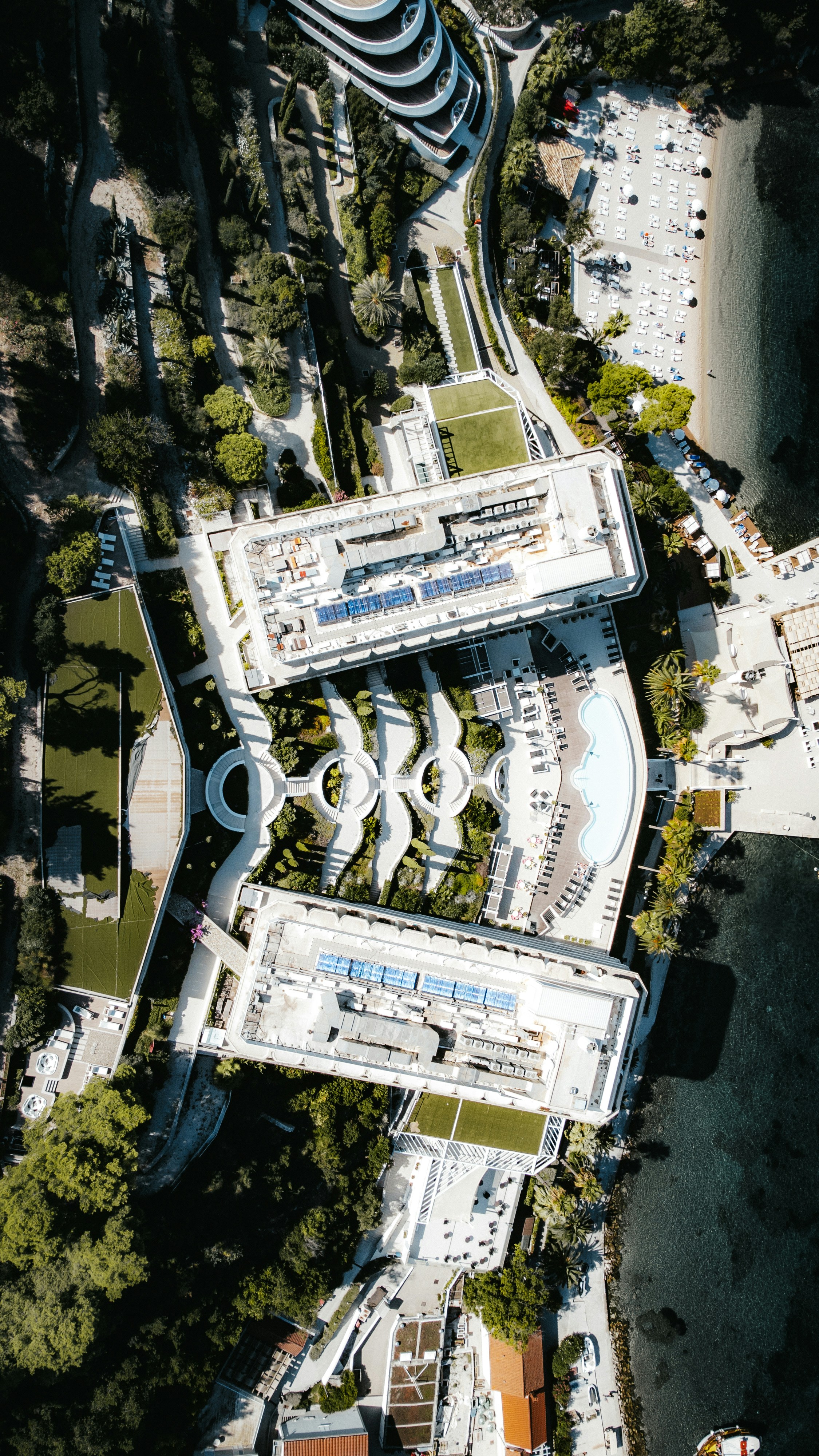 Aerial view of a luxury resort by the water.