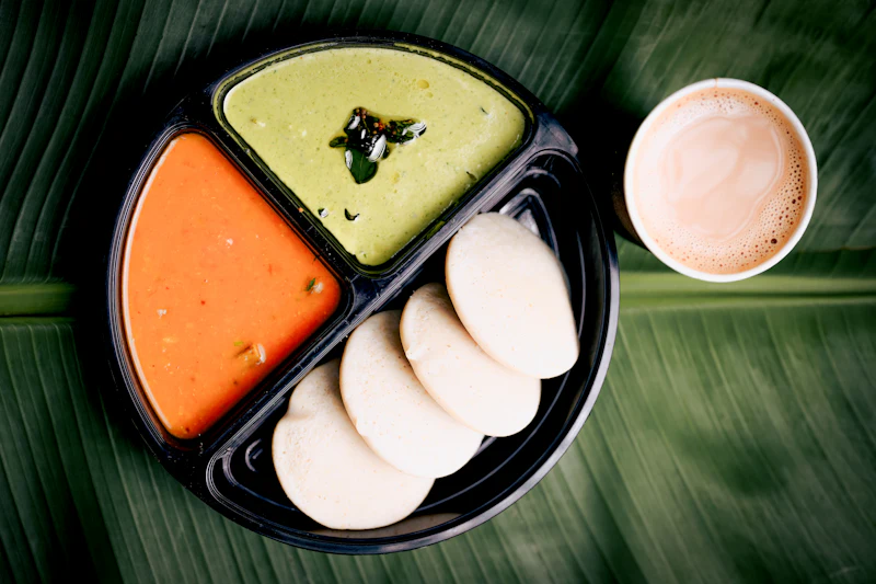 Idli, sambar and chutney served with a cup of coffee