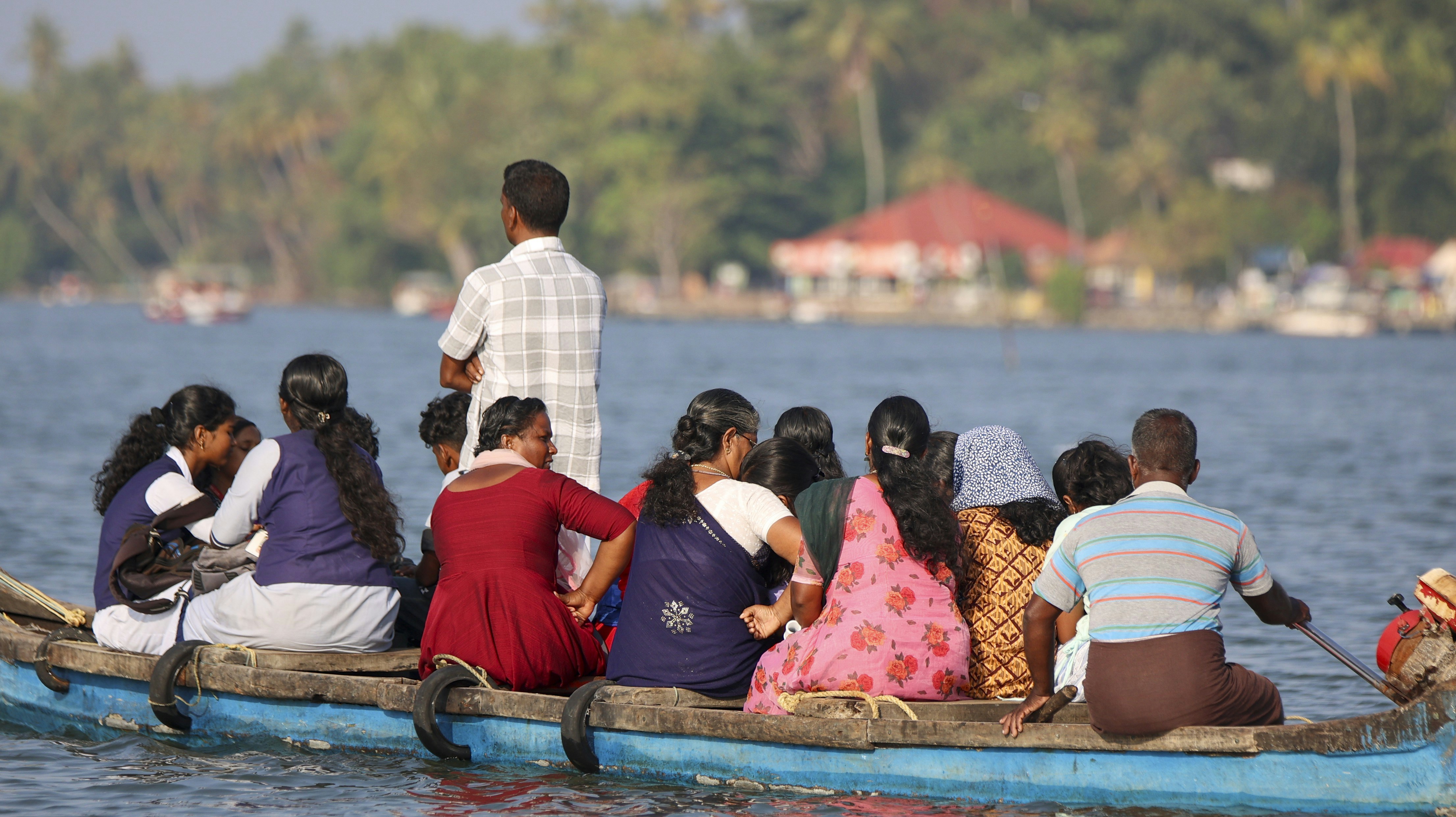 People are on a boat sailing across the water.