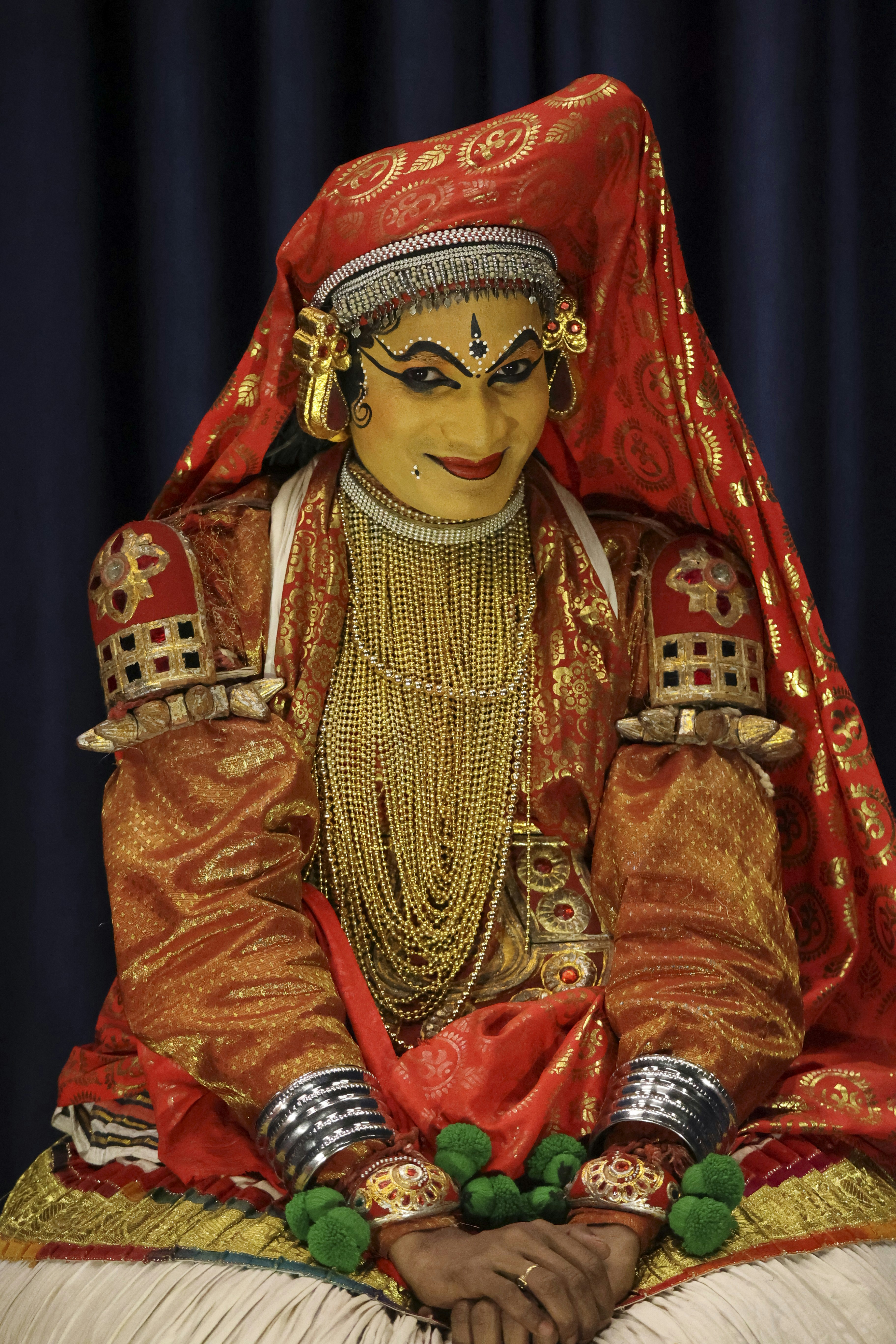 A kathakali dancer poses in vibrant traditional costume.