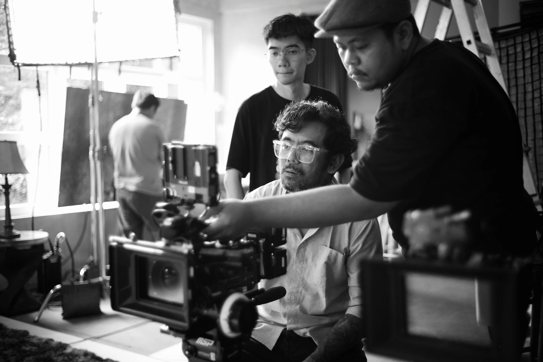 Film crew members setting up a camera.