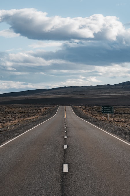 An open road stretching toward a distant horizon under a clear sky, representing a DTC brand deciding whether to enter a new market