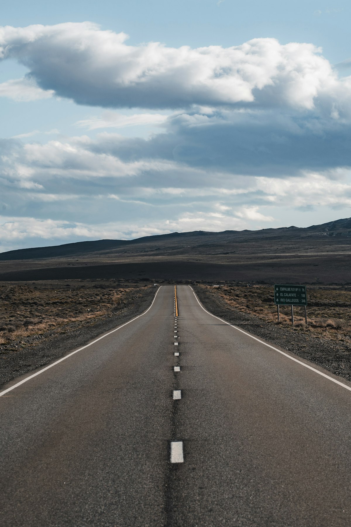 An open road stretching toward a distant horizon under a clear sky, representing a DTC brand deciding whether to enter a new market