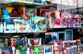 Toys are displayed inside of a store window.