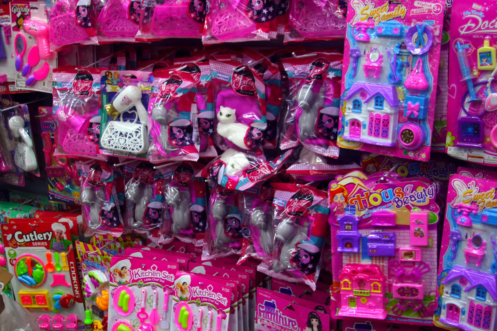 Pink toys and accessories are displayed for sale.