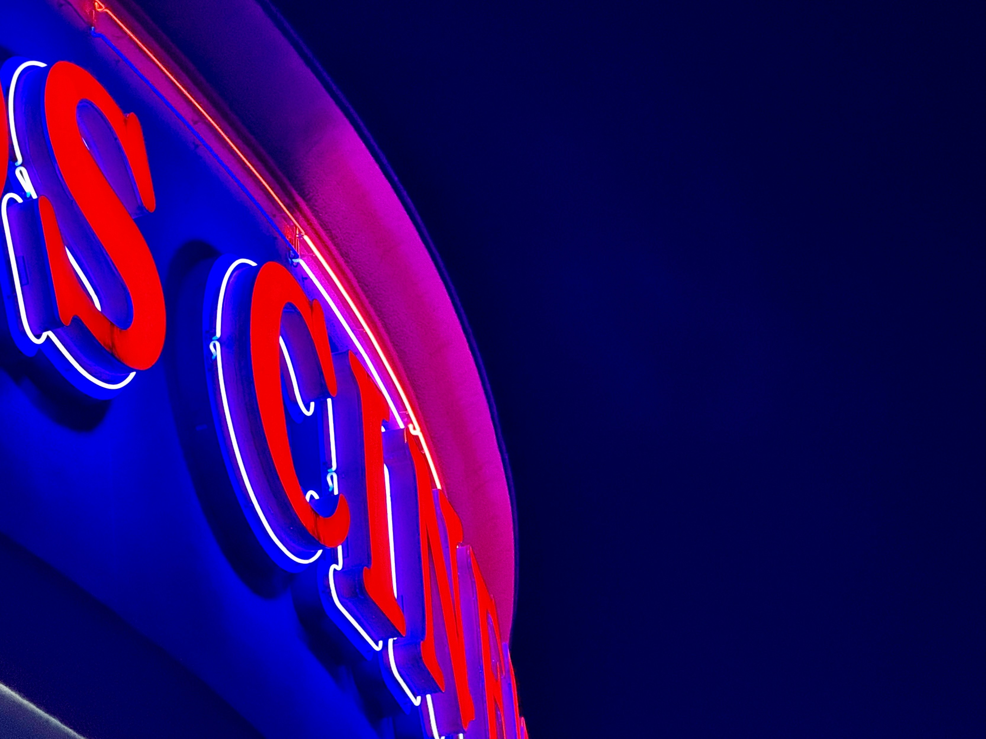 Neon sign glows against a dark blue background.
