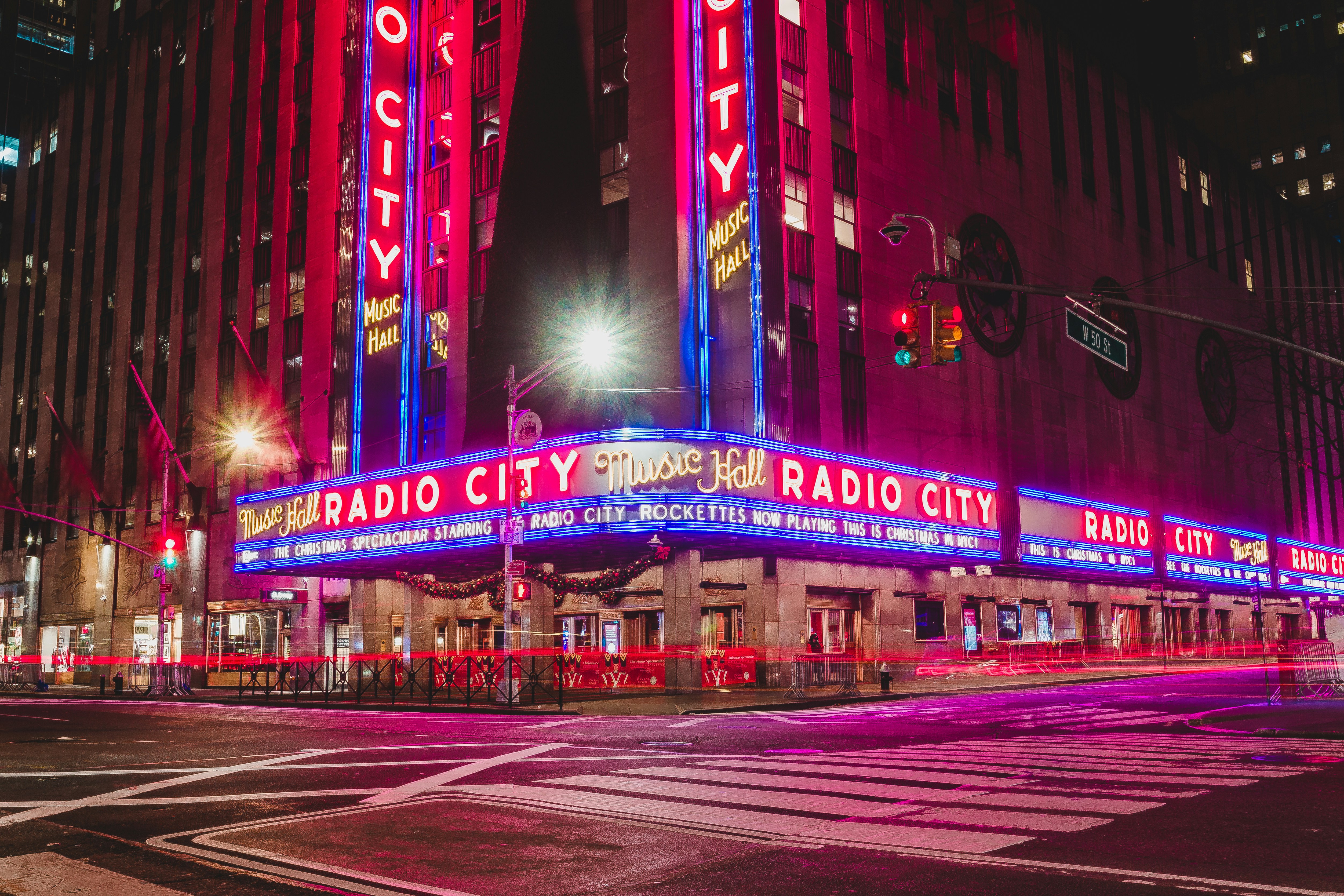 Radio city music hall lit up at night.