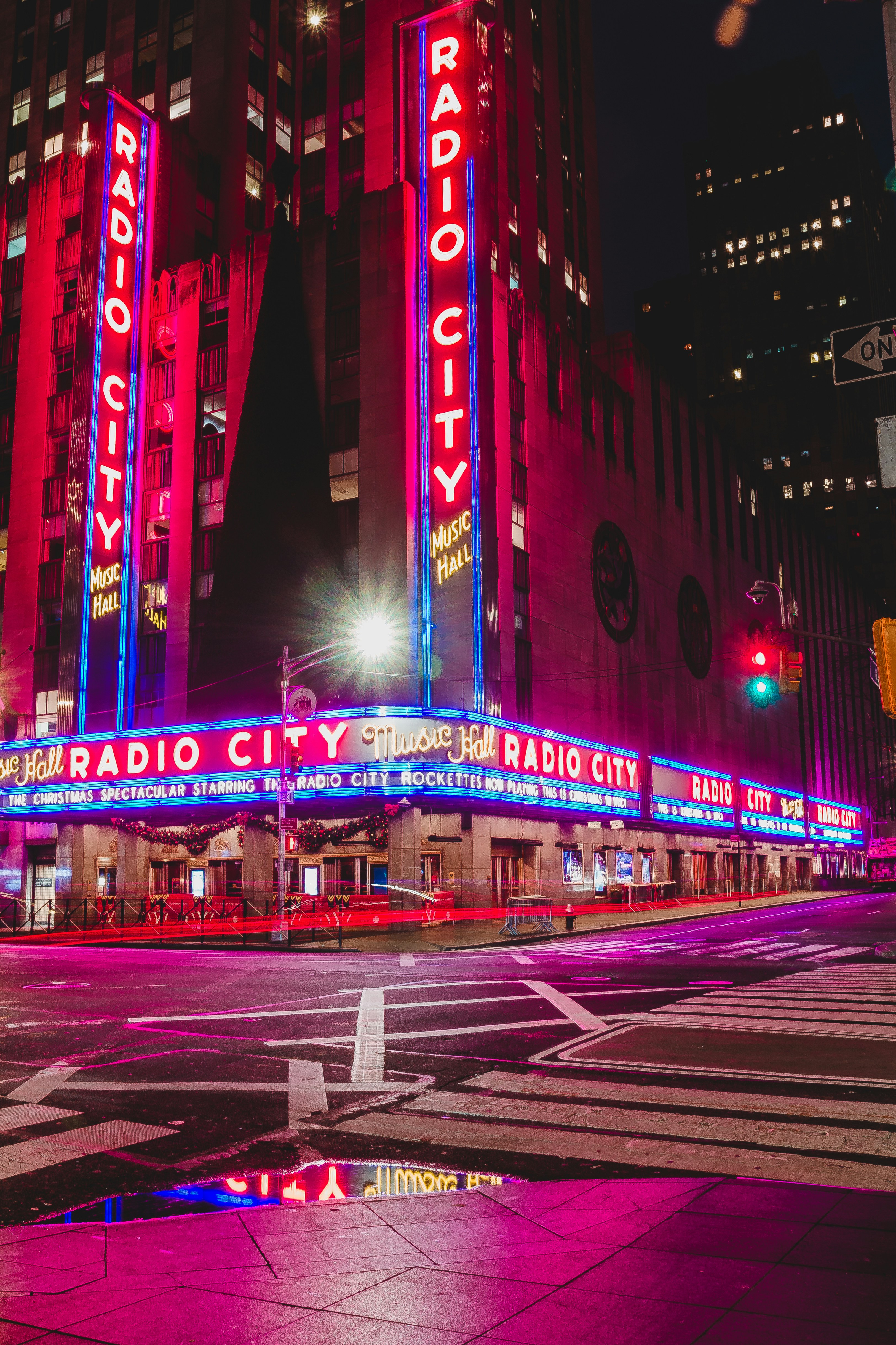 Radio city music hall illuminated at night.