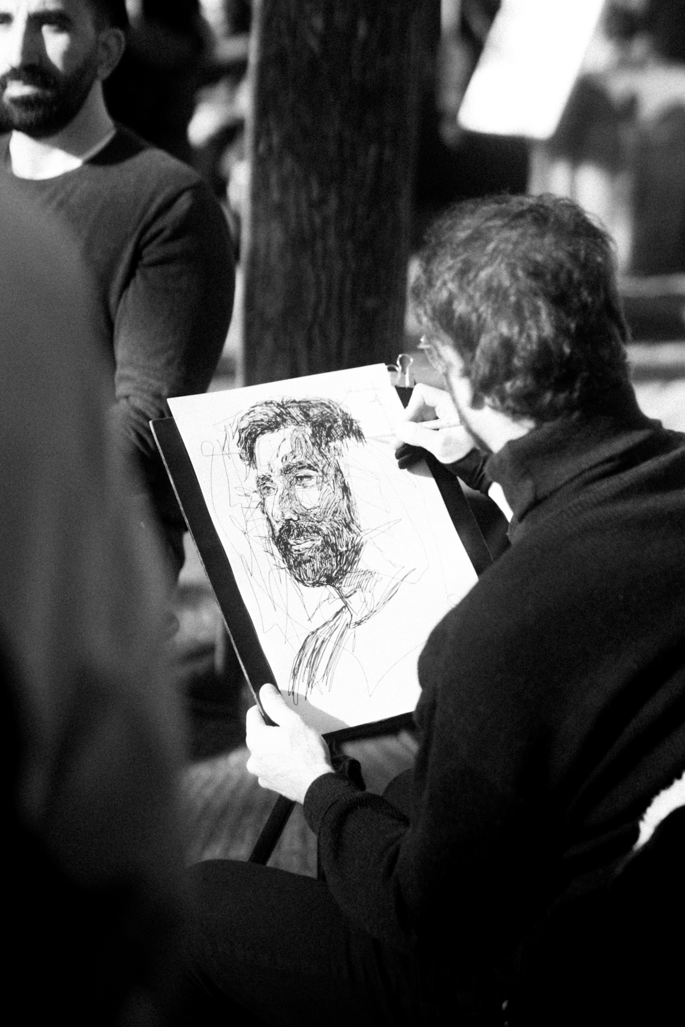 Artist draws a portrait of a man.