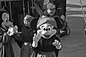 Mickey and minnie mouse wave to the crowd.