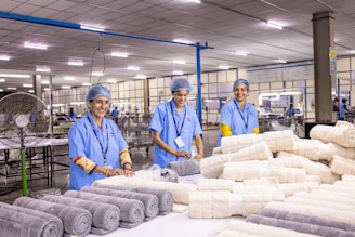 Workers at a textile factory produce rolled towels.