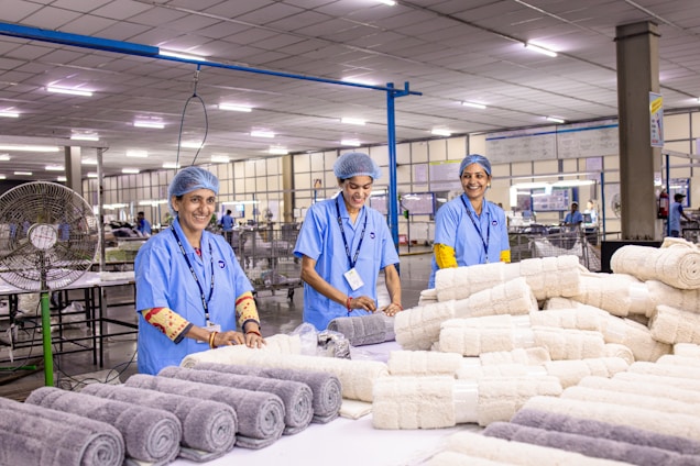Workers at a textile factory produce rolled towels.