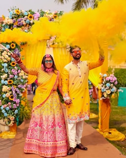Couple celebrates with colorful smoke during a wedding.