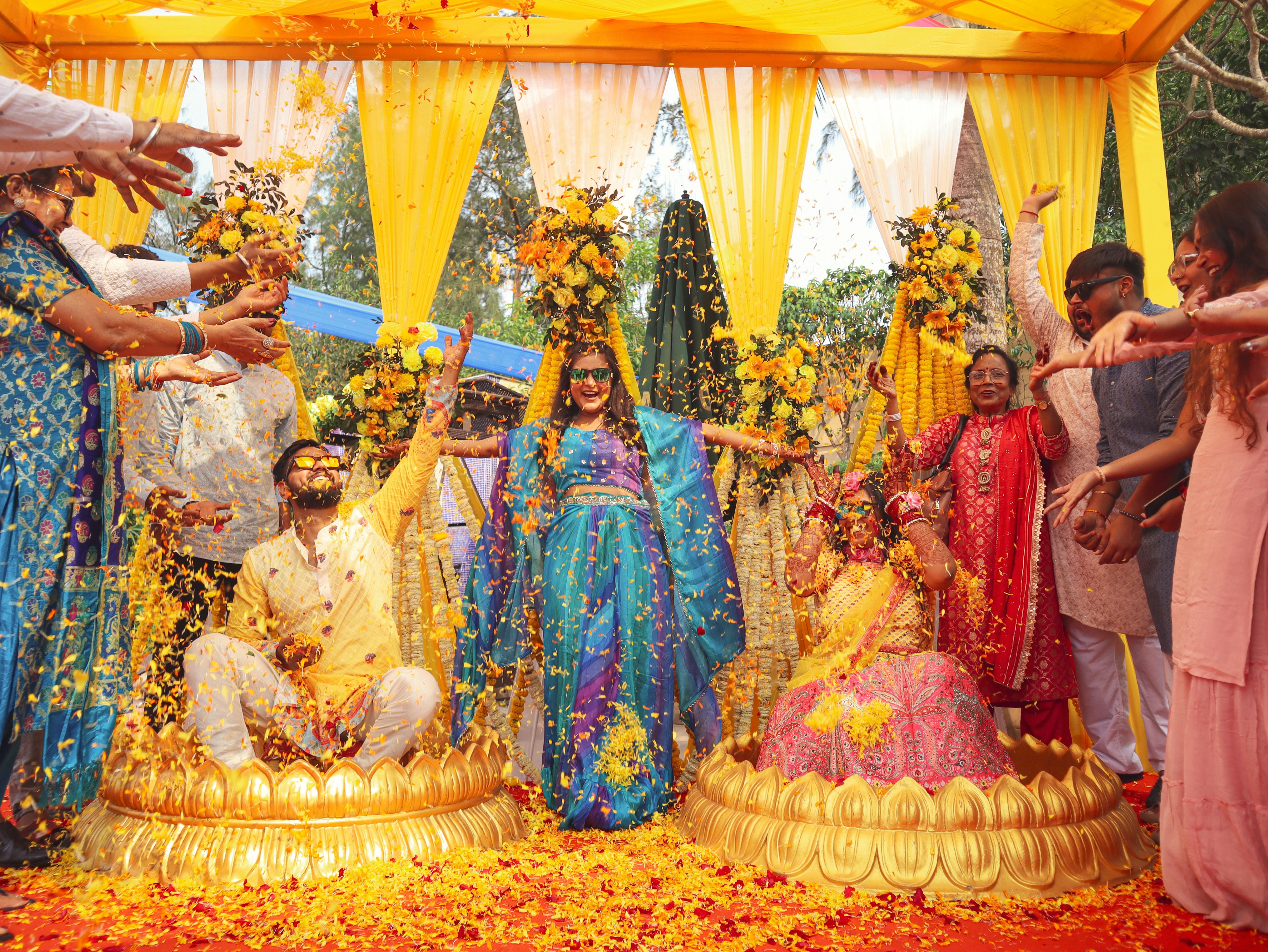 People celebrate with flowers at a traditional wedding.