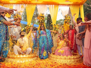 People celebrate with flowers at a traditional wedding.