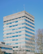 Modern office building against a clear, blue sky.
