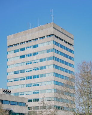 Modern office building against a clear, blue sky.