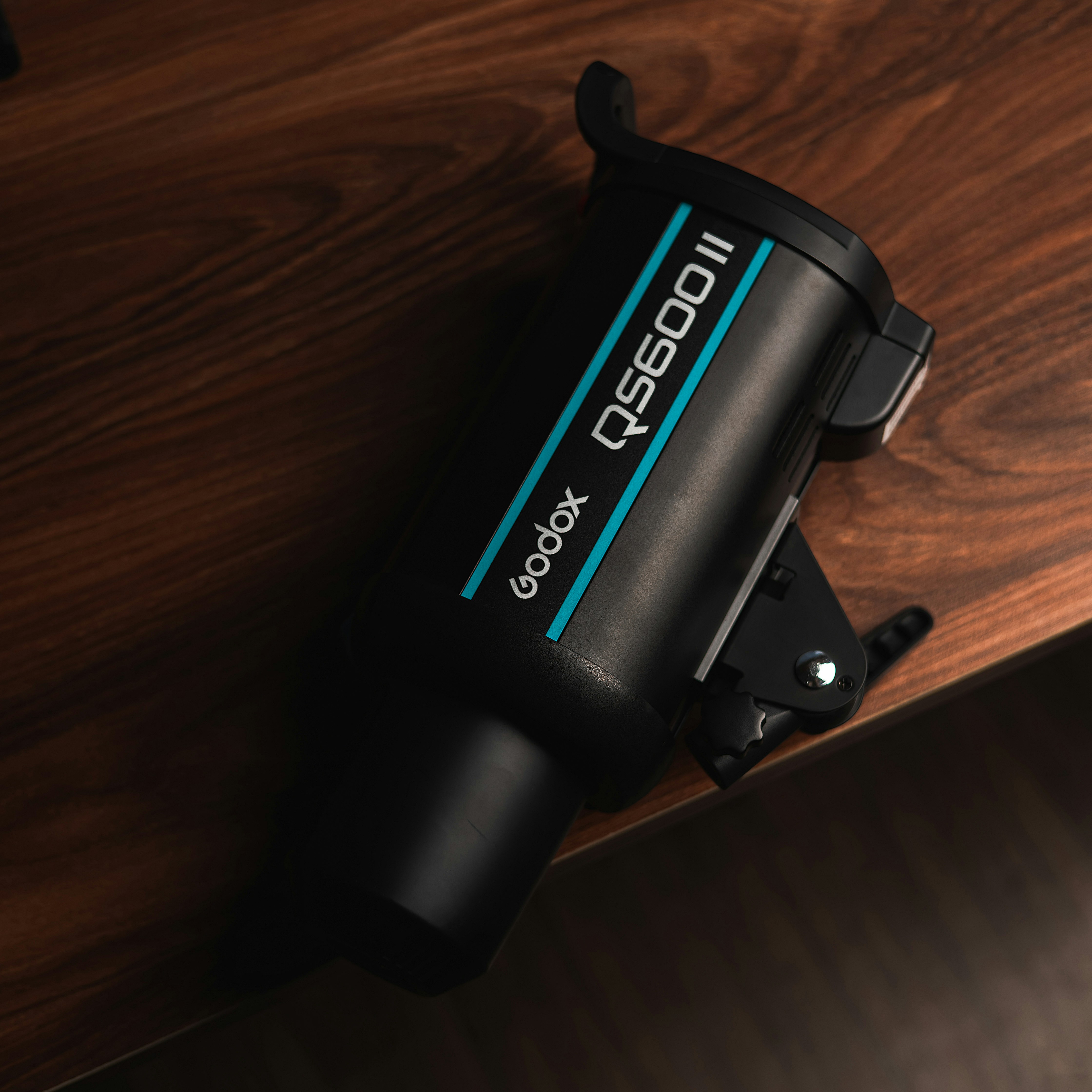 A godox qs600ii studio flash unit sits on a table.