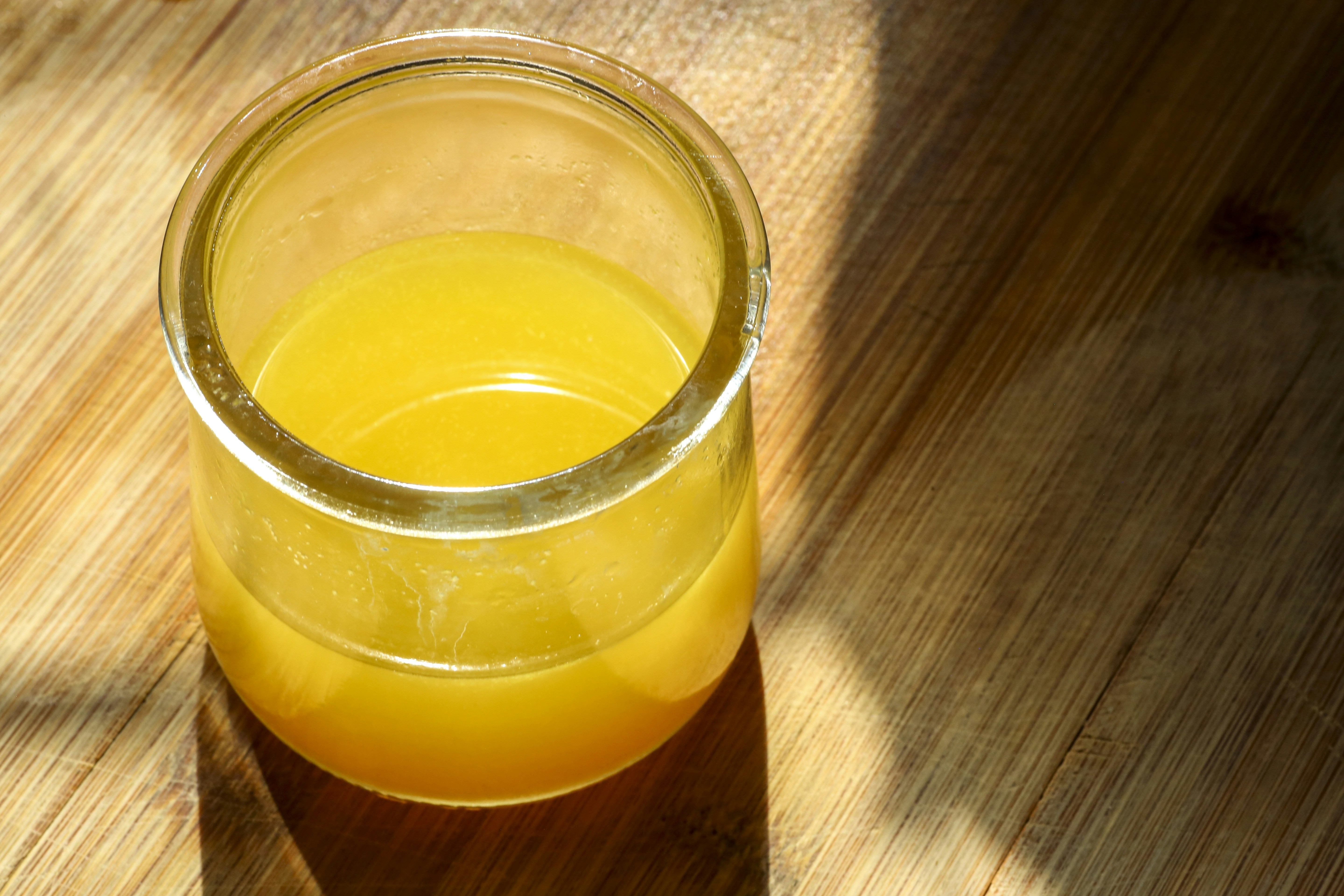 Yellow liquid in a glass jar.