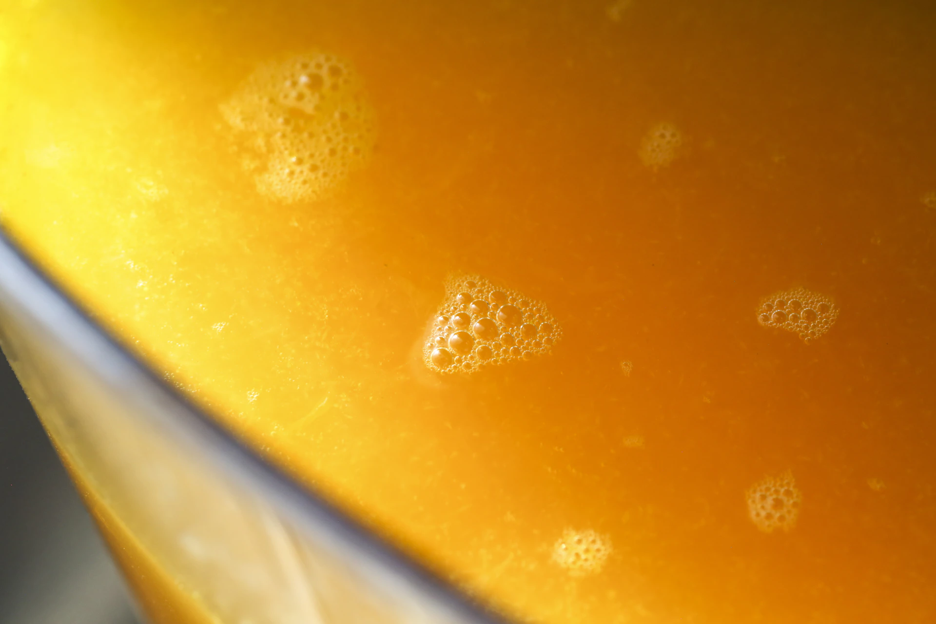 Orange liquid with tiny bubbles.