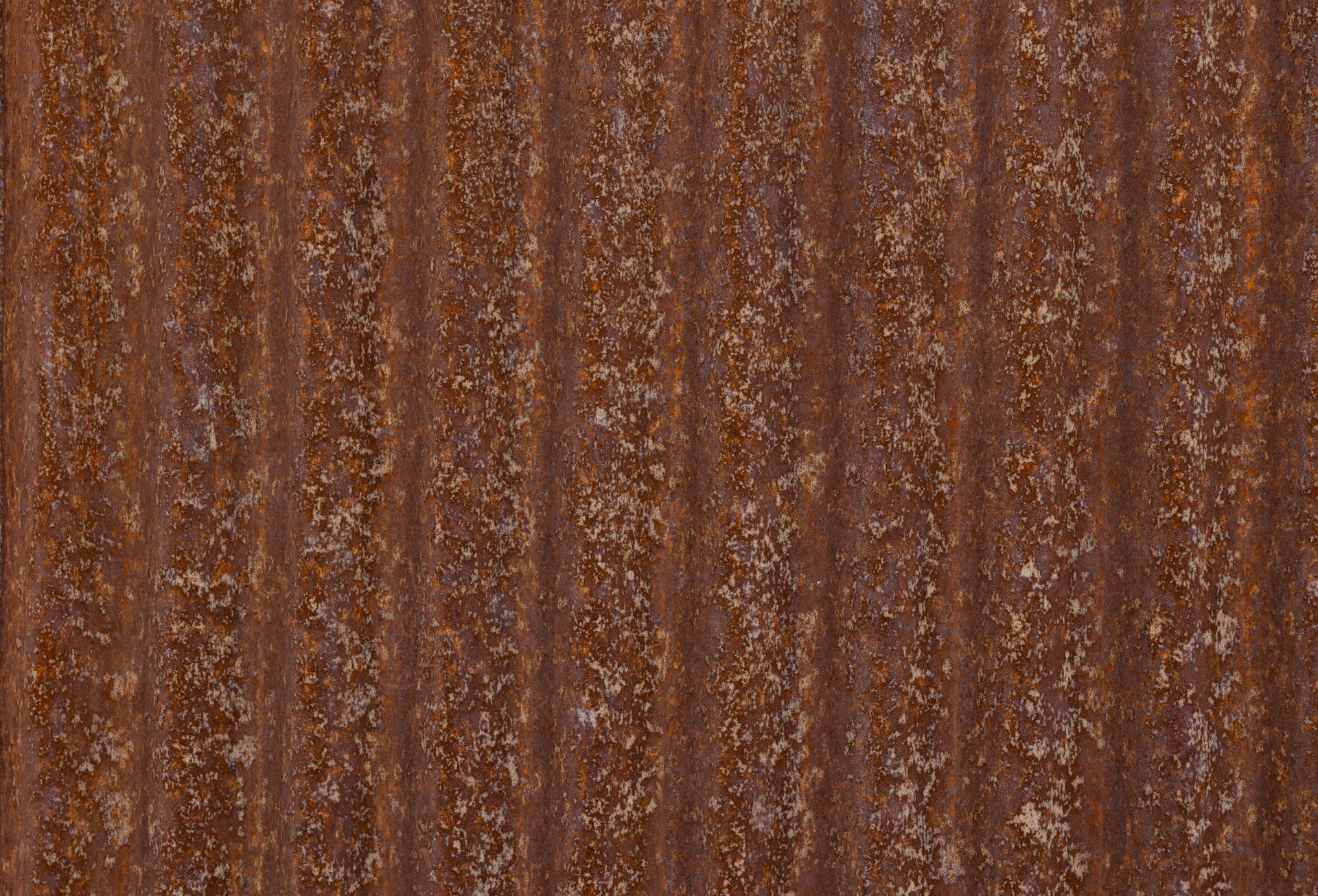 Rusty corrugated metal with vertical lines.