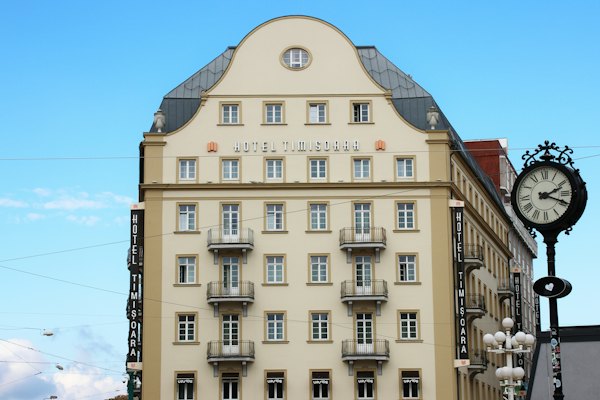 A stately hotel stands tall against the blue sky — Timișoara, Romania